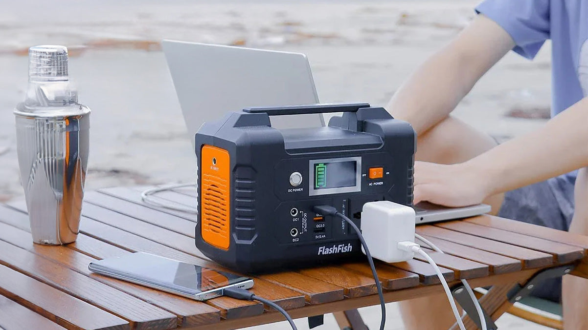 Person using portable power station to work on laptop